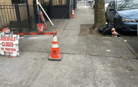 Sidewalk fenced off while crews repair damaged concrete
