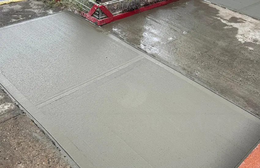 Freshly poured concrete sidewalk flags with a protective barrier in New York City, sidewalk repair by Sidewalk Repair Near Me in NYC