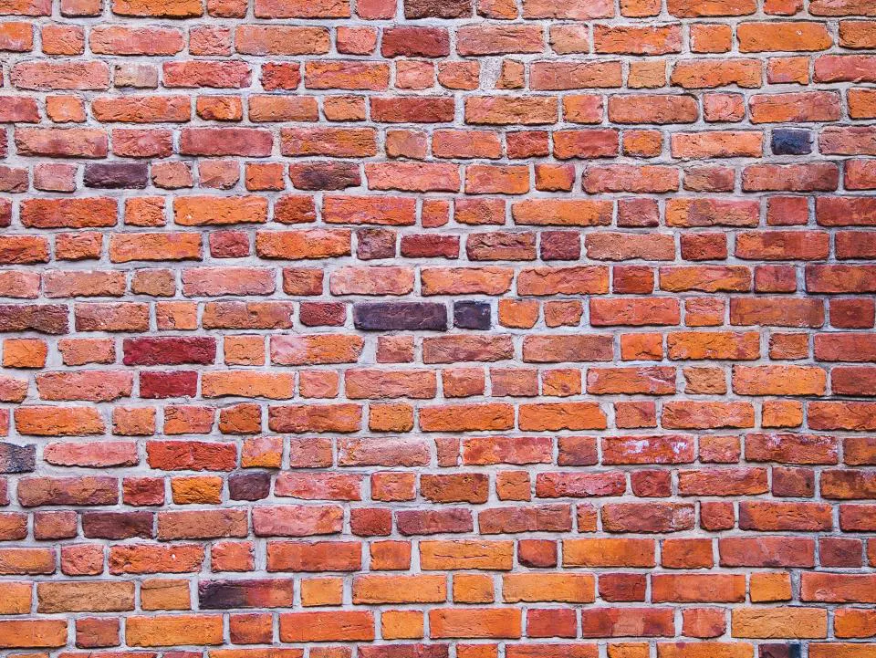 Wall of mixed red and orange brick