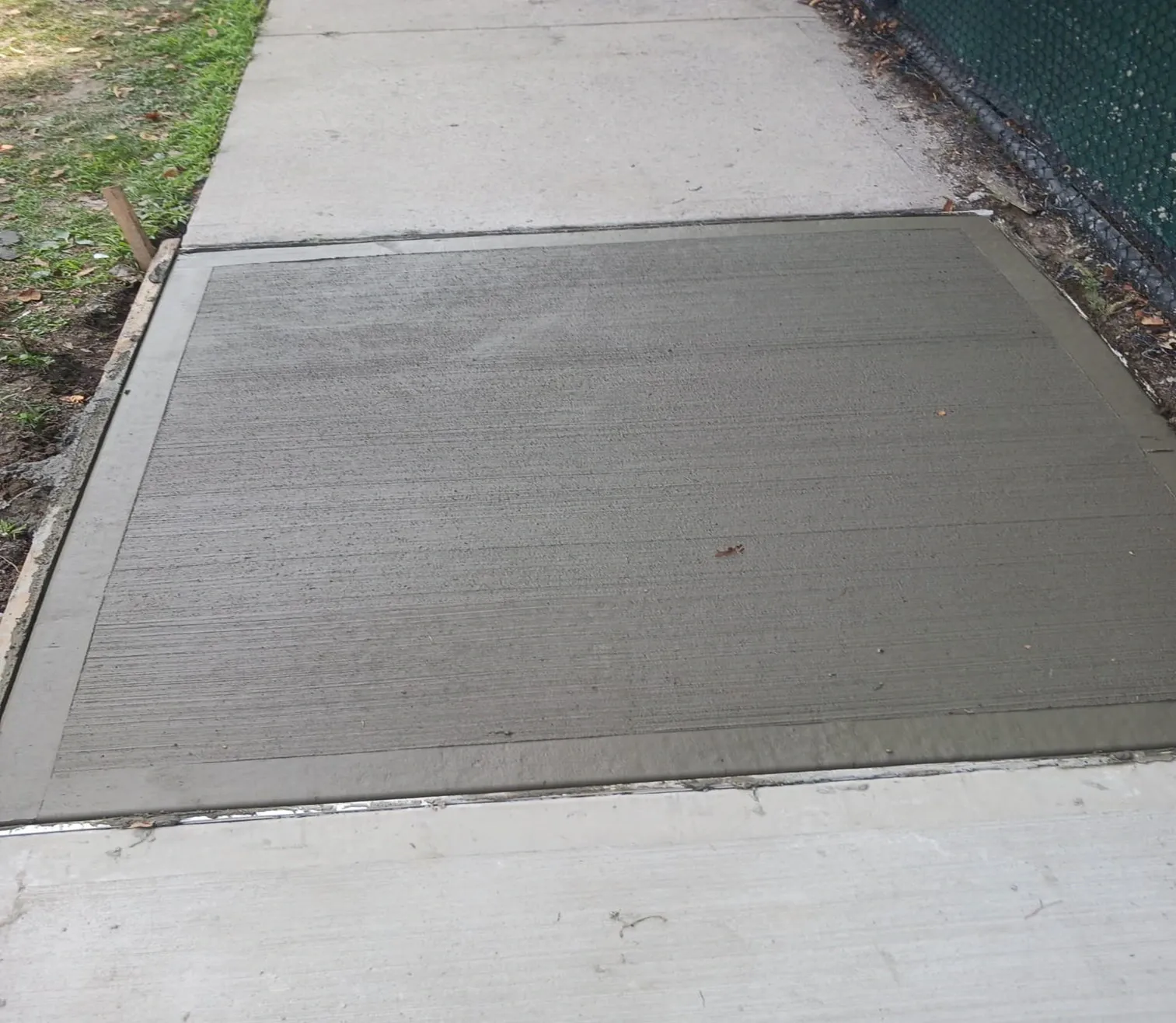 New broom finished sidewalk flag set into an older sidewalk, concrete work by Sidewalk Repair Near Me in NYC