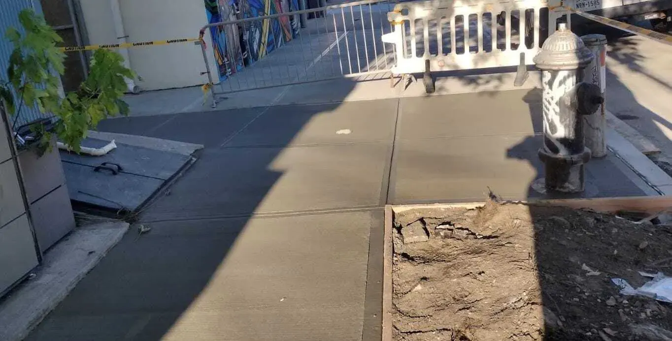 New concrete sidewalk around a fire hydrant with a tree pit formed in, sidewalk repair by Sidewalk Repair Near Me in NYC