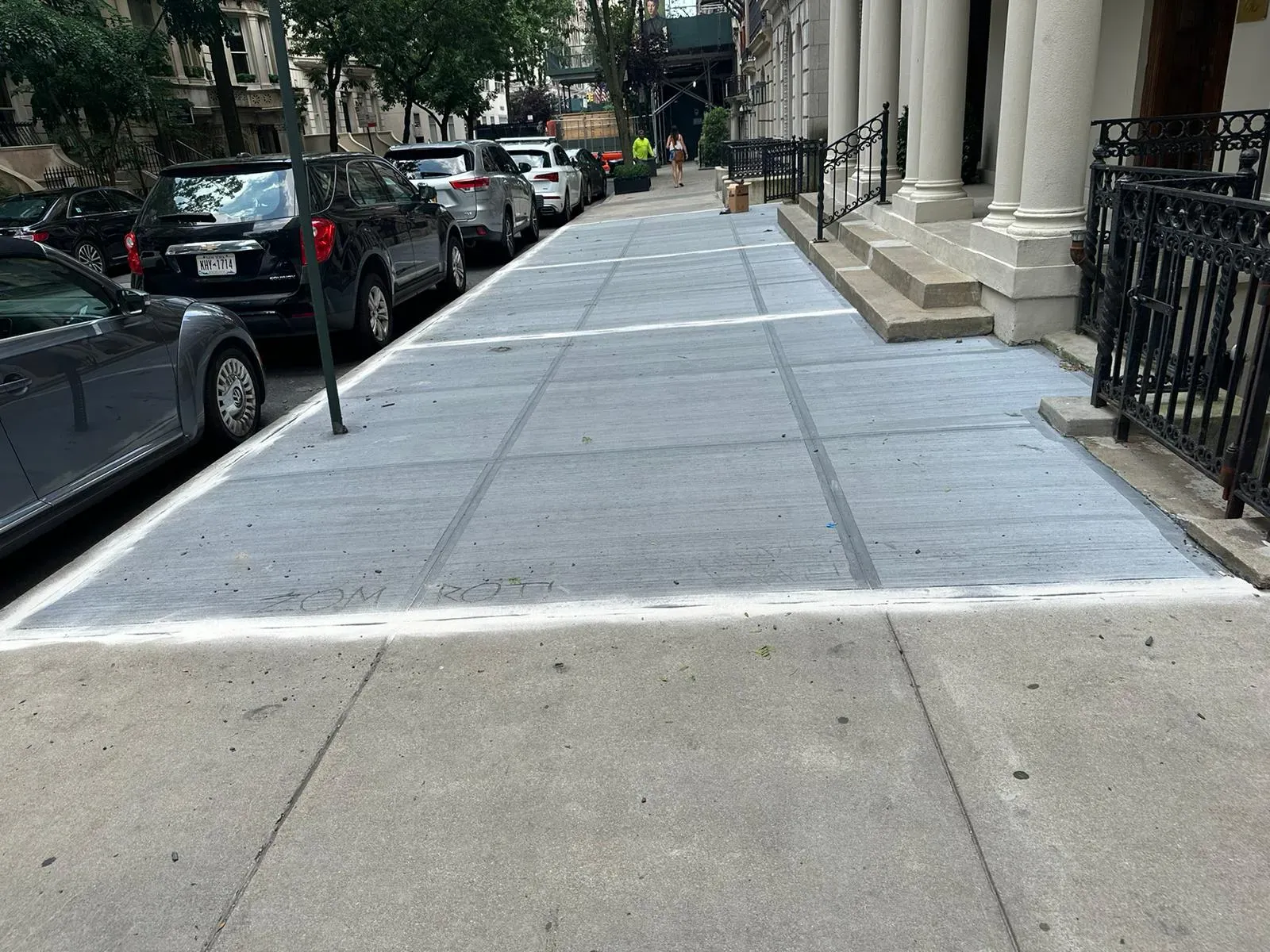 New sidewalk flags running past stoops and parked cars, sidewalk repair by Sidewalk Repair Near Me in NYC