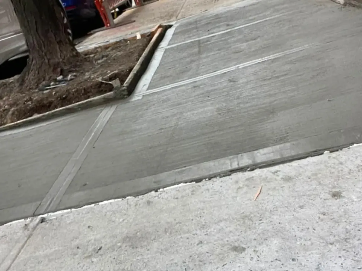 New concrete sidewalk beside a street tree pit on the Upper West Side, sidewalk repair by Sidewalk Repair Near Me in NYC