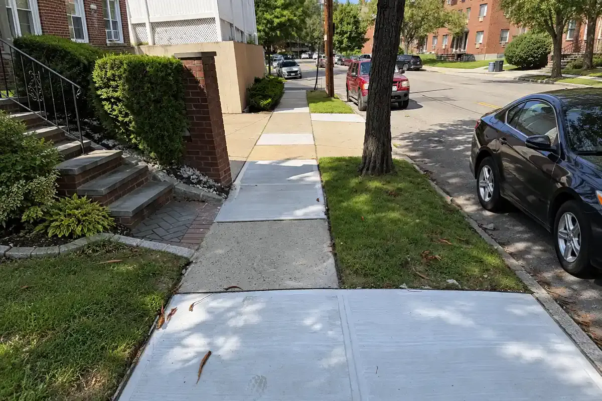 Repaired sidewalk flags on a residential block in Whitestone, Queens, sidewalk repair by Sidewalk Repair Near Me in NYC
