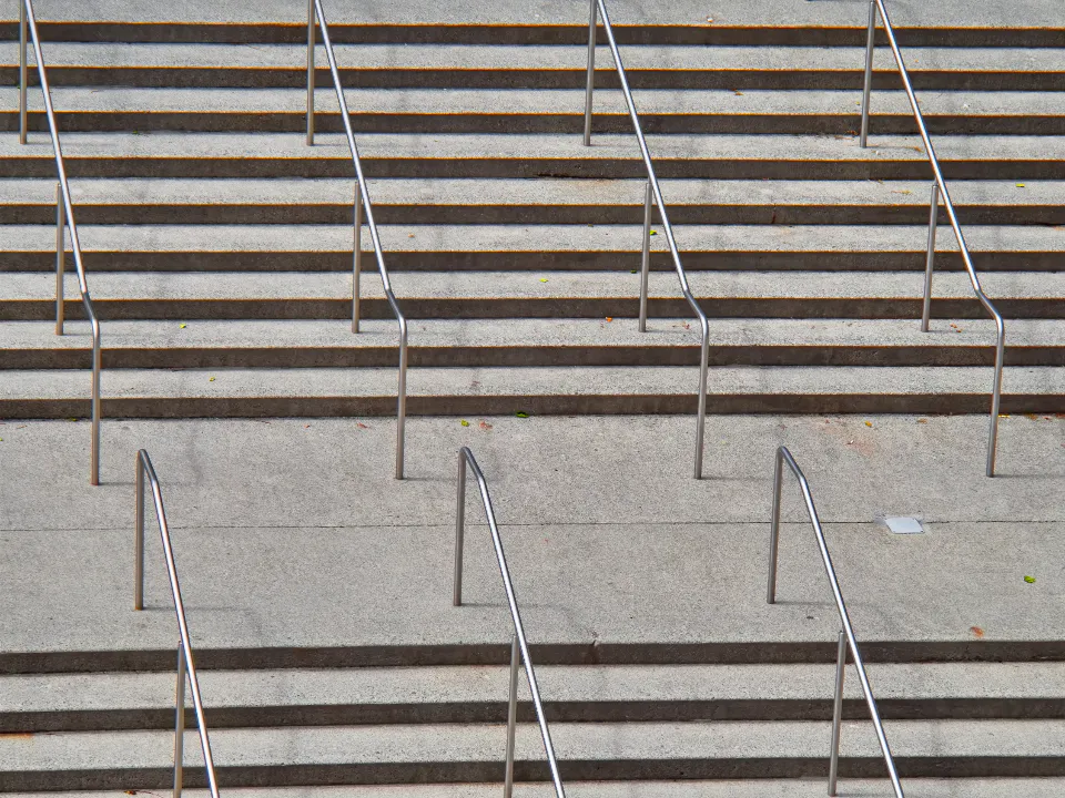 Wide concrete steps with steel handrails
