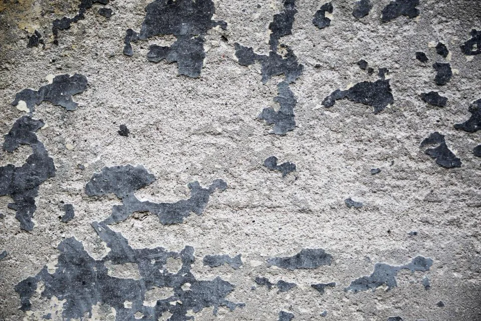 Concrete wall with an old coating flaking off