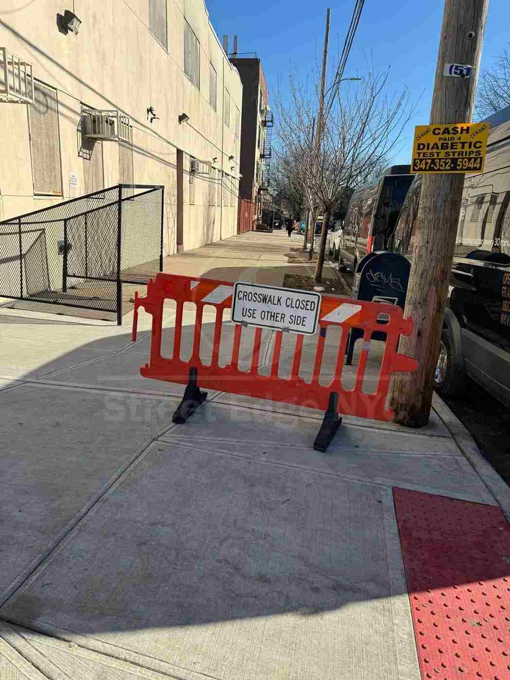 Cracked NYC sidewalk creating a trip hazard for pedestrians